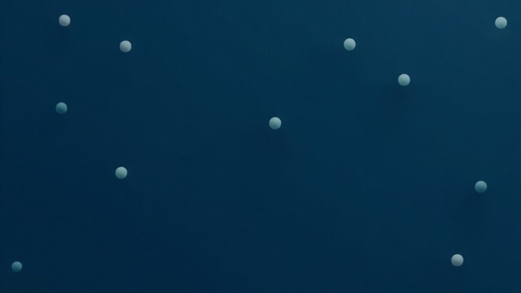 Minimal abstract editorial illustration for Generalist AI GEN-1.5 robot learning, showing small teal dots on a deep navy and slate gray background.